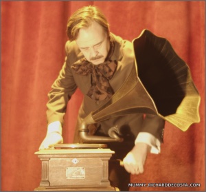 Poe character beside a Victrola in an archival opera image